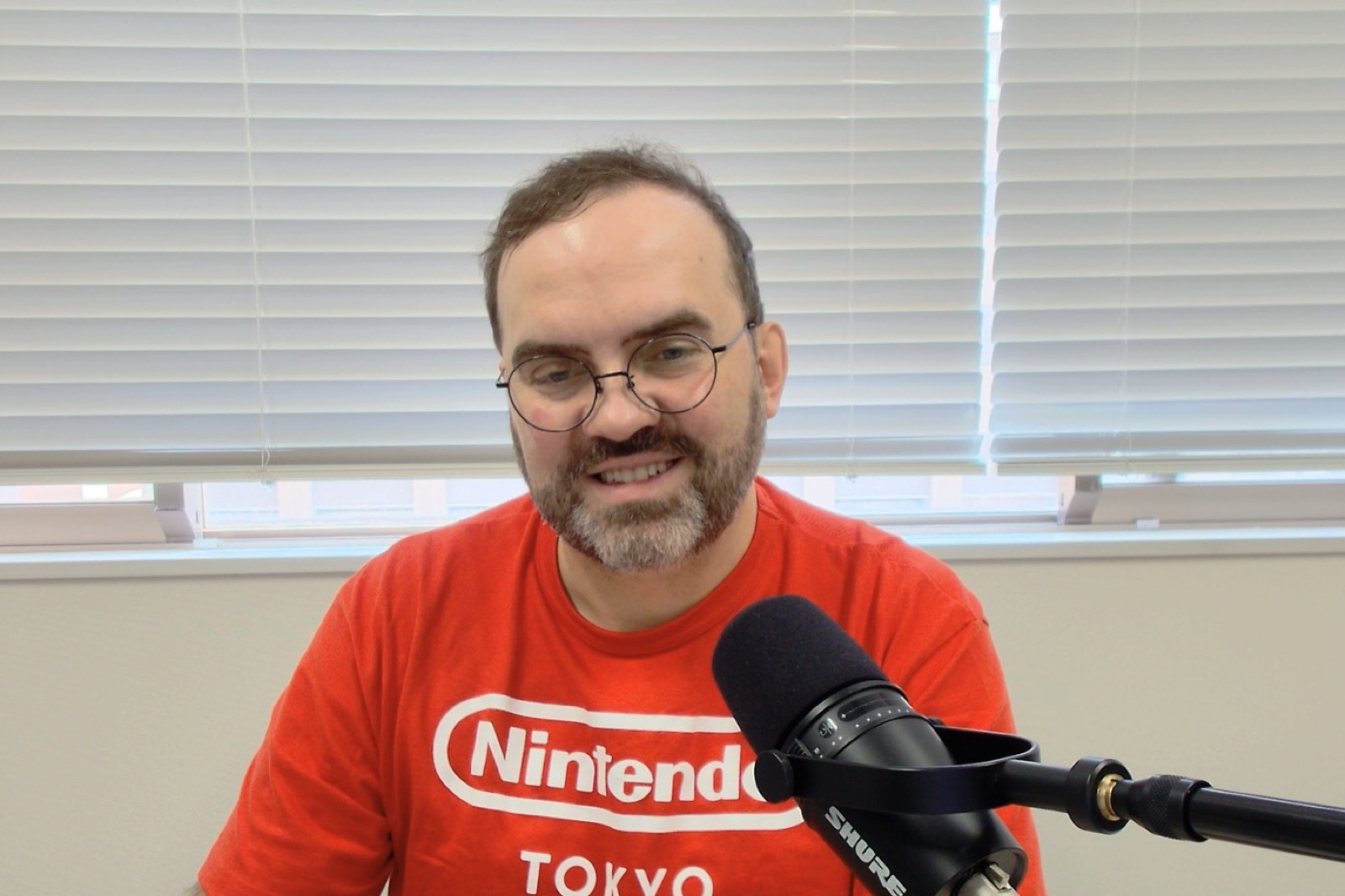 Michal Mazur recording a podcast episode with a microphone.