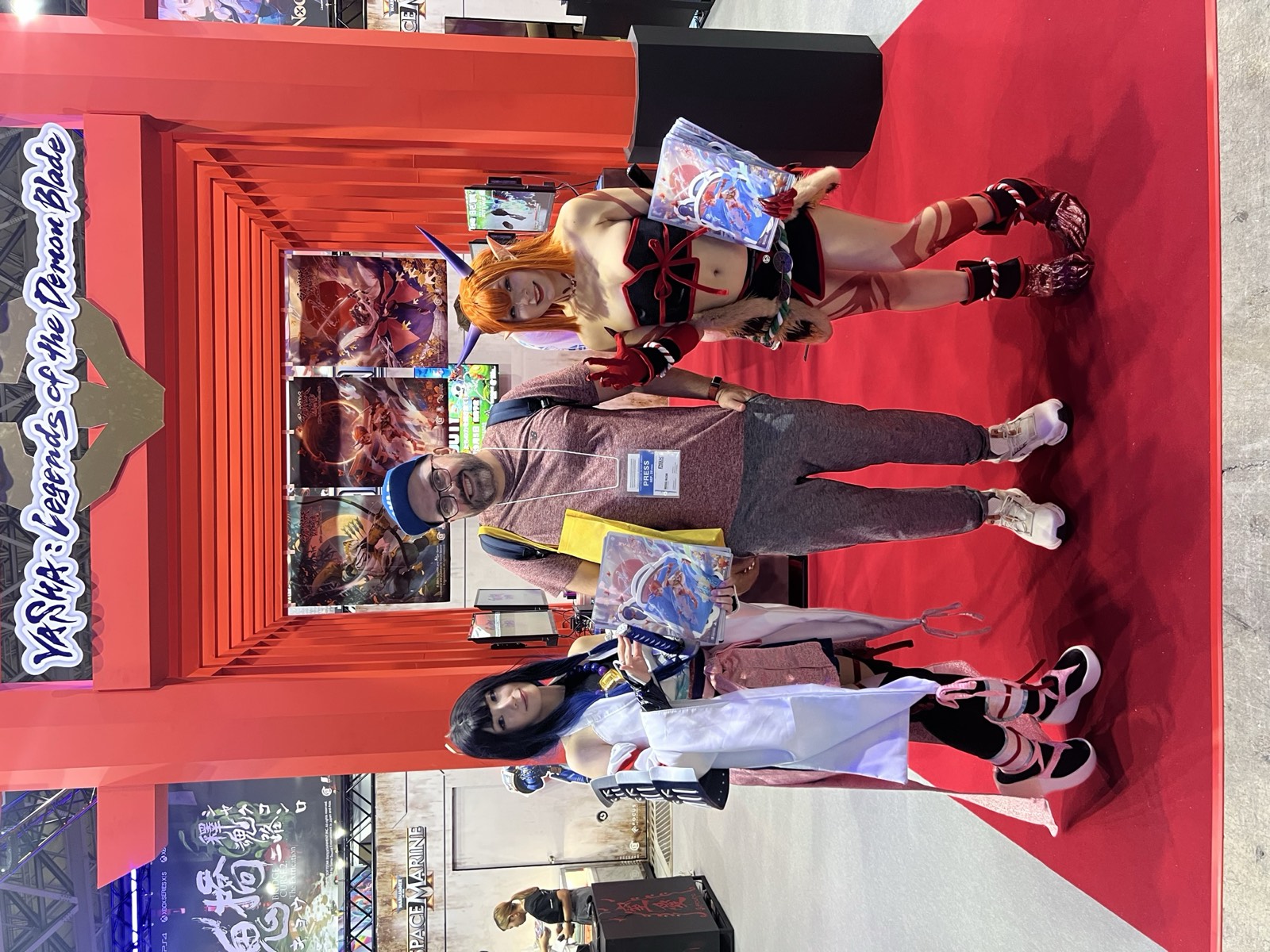 Michal Mazur at a Tokyo Game Show booth with a visible press badge, used as the visual for the interactive editorial story.